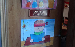 A classroom door featuring a sign saying Confucius Classroom