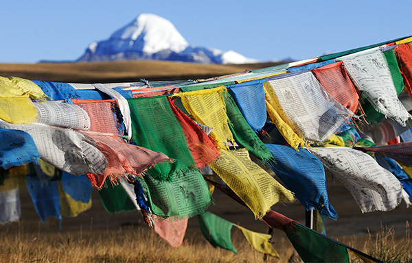 Prayer flags flutter in front of Mount Kailash